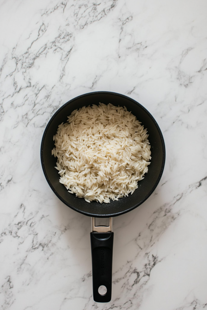 toasting-orzo-and-rice-in-a-pan-before-adding-broth-5517934-683x1024