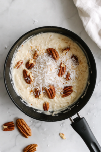adding-pecans-coconut-to-frosting-in-saucepan