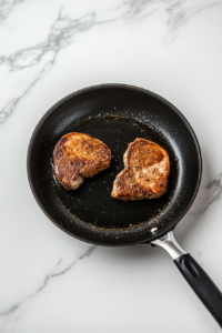 avocado-oil-heating-black-skillet-marble-cooktop