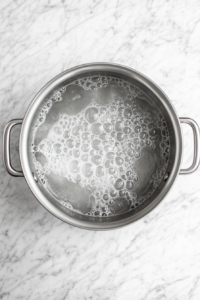 boiling-lightly-salted-water-in-stainless-steel-pot-on-marble