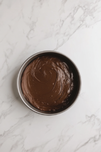 cake-batter-in-round-cake-tin-on-marble