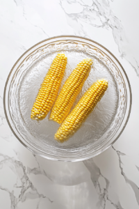 corn-soaking-in-cold-water-in-clear-glass-bowl
