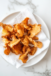 crispy-fried-mushrooms-draining-on-paper-towels