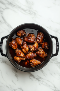 crockpot-asian-chicken-cooking-in-black-dutch-oven-on-marble