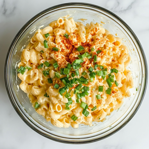 deviled-egg-pasta-salad-in-white-bowl-on-marble