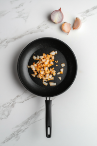 diced-onion-caramelizing-in-black-skillet