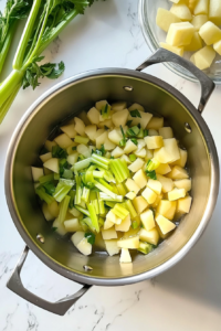 diced-potatoes-celery-onion-in-stainless-pot-on-marble-top
