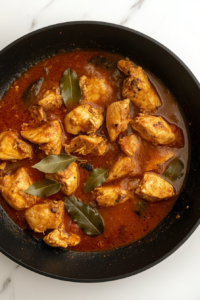 finished-chicken-cooked-tender-oil-separated-from-sauce-black-skillet