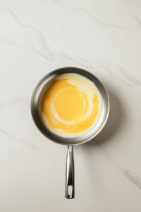 folding-egg-yolks-into-warm-mixture-off-heat-white-marble