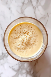 folding-soft-peak-egg-whites-into-souffle-base-in-glass-bowl