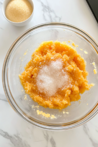 glass-bowl-with-eggs-sugar-pumpkin-mixture-top-down