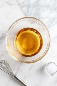 greek-salad-dressing-in-clear-glass-bowl-on-white-marble