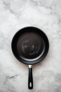 heating-half-inch-neutral-oil-in-black-skillet-vegan-fried-chicken