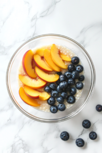 mixing-peaches-blueberries-with-lemon-sugar