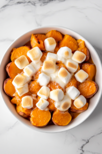 mushy-sweet-potatoes-with-melted-marshmallows-on-white-ceramic-plate