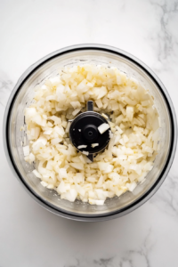 bright-and-fresh-homemade-salsa-in-clear-glass-bowl-on-white-marble