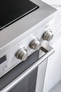 This image shows a close-up of a stainless steel oven control panel set to 350°F on a white marble countertop.