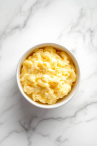 serving-mac-and-cheese-in-white-ceramic-bowl-on-marble-2