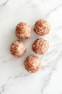 shaped-tuna-mixture-golf-ball-size-on-white-marble