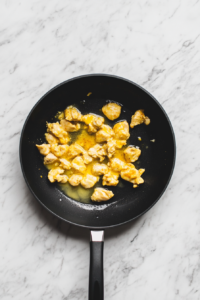 spiced-chicken-cooking-in-single-handle-black-skillet-for-keto-butter-chicken