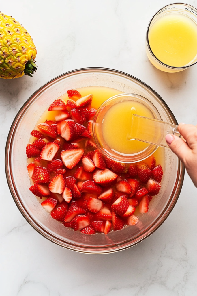 top-down-shot-of-pineapple-juice-and-lemon-juice-being-poured-into-a-punch-bowl-6100723-683x1024
