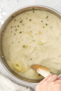 Add shredded cheese gradually, stirring until fully melted.