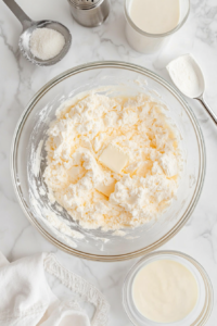 adding-dry-ingredients-and-buttermilk-to-creamed-mixture-on-marble