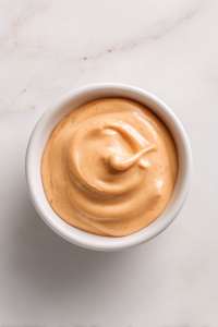 spicy-mayo-in-small-white-round-bowl-on-marble