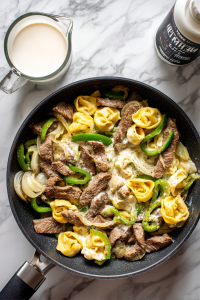 adding-cheese-tortellini-and-cream-to-skillet