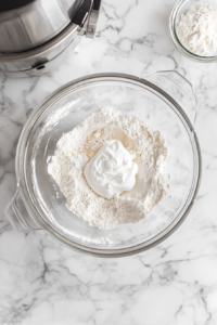 adding-dry-ingredients-and-sour-cream-to-mixer-bowl