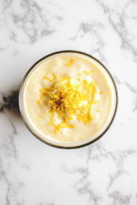 adding-lemon-zest-extracts-to-pound-cake-batter-in-glass-bowl