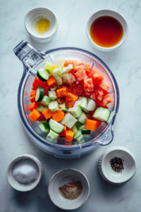 adding-liquid-and-seasoning-to-gazpacho-blender