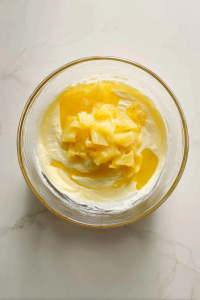 adding-pineapple-lemon-vanilla-to-batter-glass-bowl