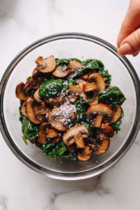 adding-seasoning-to-the-bowl-of-sauteed-mushrooms