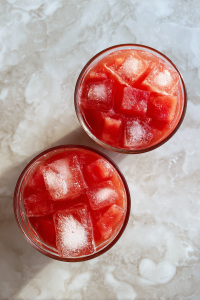 adding-watermelon-puree-to-ice-filled-glasses