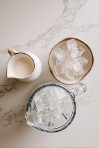 adjusting_smoothie_texture_with_milk_and_ice_next_to_blender