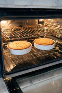 baked-carrot-cakes-cooling-on-black-wire-rack-over-white-marble