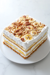 banana-split-cake-slice-served-on-white-round-ceramic-plate