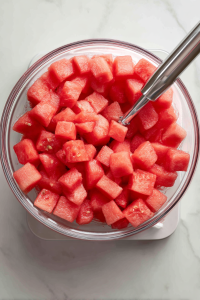 blending-watermelon-in-glass-bowl-white-marble