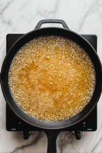 boiling-chicken-broth-in-black-skillet-for-orzo