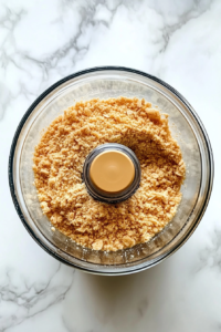 butter-and-sugar-added-to-crumbs-in-processor