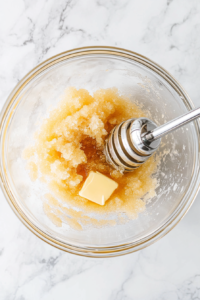 butter-brown-sugar-honey-mixing-in-glass-bowl