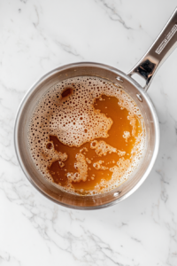 caramel-boiling-in-saucepan-on-white-marble-medium-heat-stage