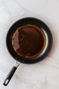 caramel-simmering-in-skillet-on-white-marble