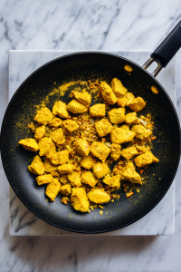chicken-coated-with-curry-powder-black-skillet