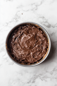 chocolate-cake-batter-in-lined-pan-on-white-marble-cooktop-2