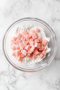 chopped-rhubarb-added-to-flour-mixture-in-glass-bowl
