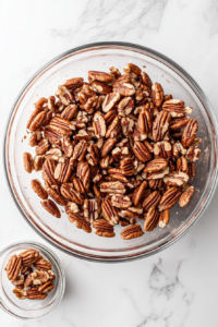 chopped-toasted-pecans-in-glass-bowl-on-white-marble