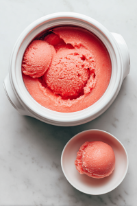 churning-watermelon-sorbet-in-ice-cream-maker-on-marble