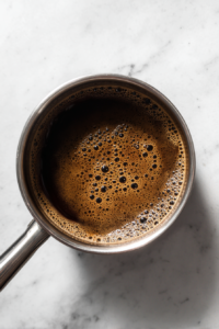 coffee-syrup-simmer-saucepan-white-marble